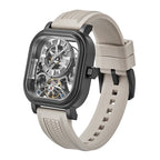 Luxury skeleton watch with carbon fiber case, beige rubber strap, and visible tourbillon, inspired by motorsport design.