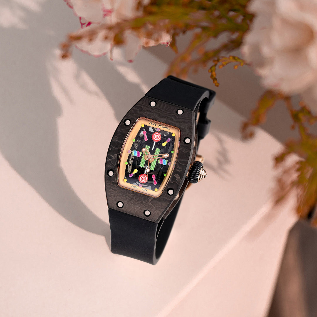 Luxury carbon fiber racing watch with a colorful artistic dial and black rubber strap.