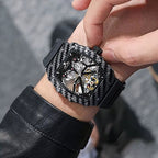 Luxury carbon fiber skeleton chronograph watch with racing-inspired design on a man's wrist.