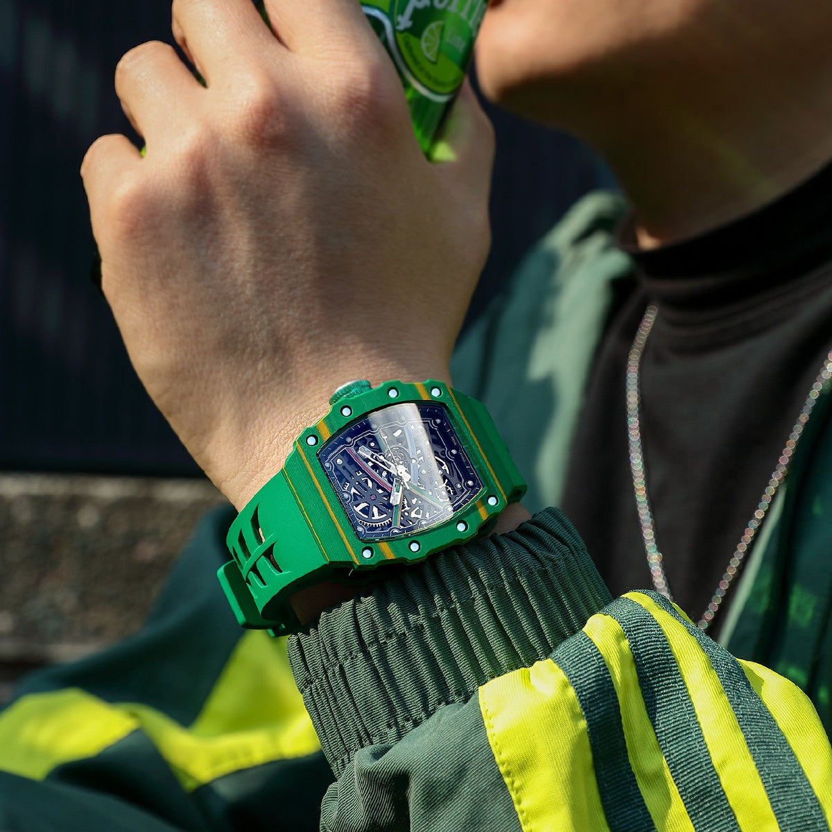 Luxury green chronograph watch with skeleton dial and racing-inspired design on a man's wrist.