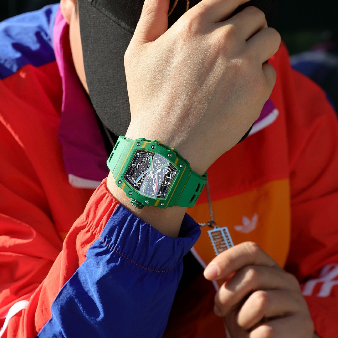 Green luxury chronograph watch with tonneau-shaped case and skeleton dial on a person's wrist.