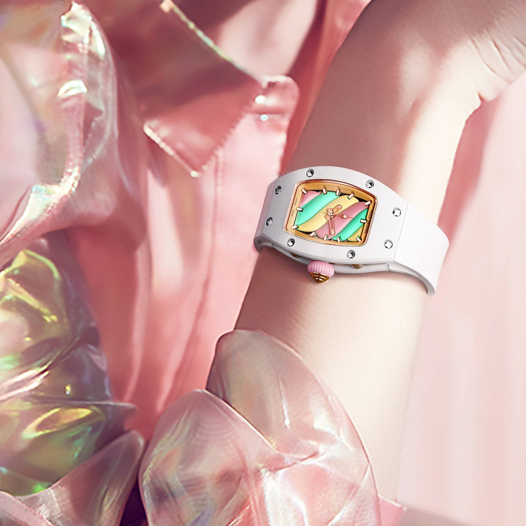 Luxury white tonneau-shaped chronograph watch with colorful skeleton dial on a wrist.