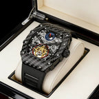 Luxury carbon fiber skeleton chronograph watch with moon phase complication in a display box.